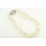 A graduated four row freshwater pearl necklet with a diamond set silver clasp,