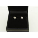 A pair of diamond stud earrings, H/M 18ct, the round brilliant cut diamonds total approx 0.