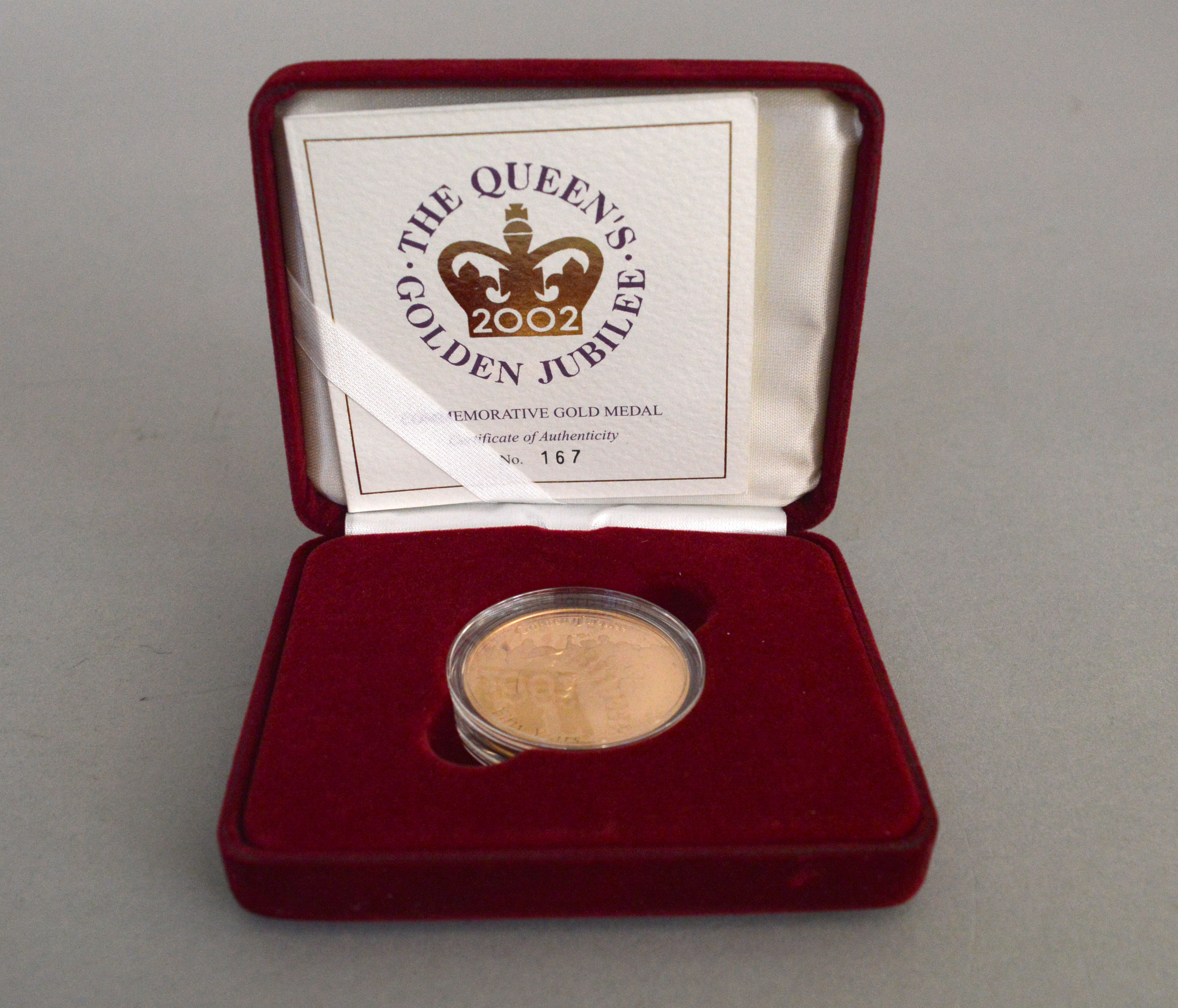 A Royal Mint 22ct gold medal commemorating The Queens Golden Jubilee, ltd edition 167 of 250,
