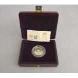 A 22ct proof £5 poppy coin, commemorating the 90th anniversary of The Royal British Legion,