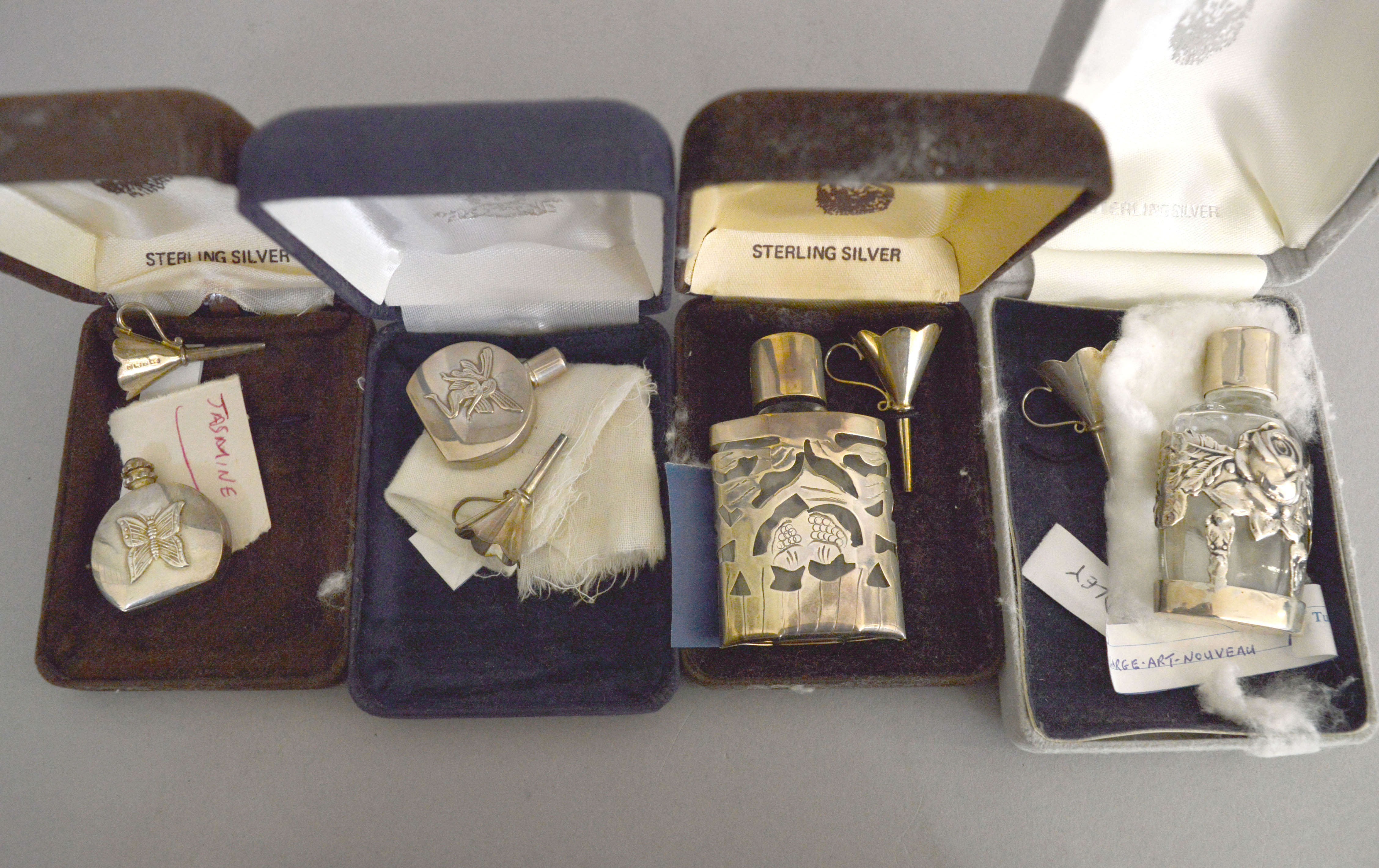 Seven silver miniature perfume bottles, all boxed with funnels