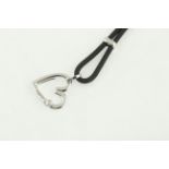FOPE. An 18 carat H/M white gold FOPE diamond set heart pendent, on a later rubber chain.