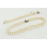 A two row cultured pearl necklet, clasp stamped sterling,