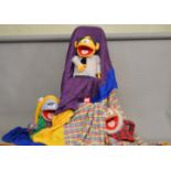 Three Muppet style puppets with tent cover.