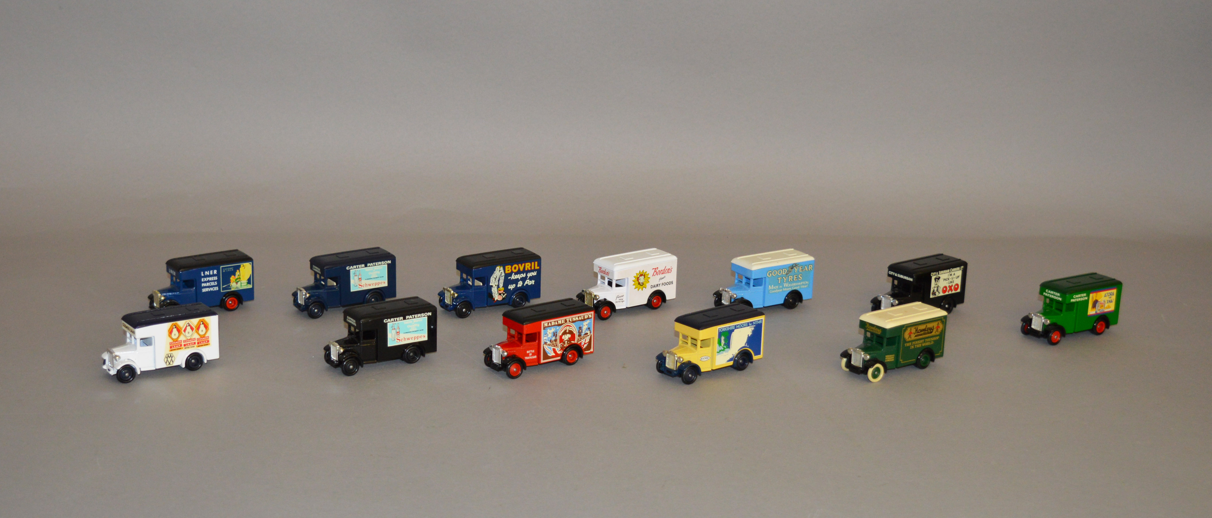 Twelve unboxed Lledo pre-production metal van models, various liveries including 'Good Year',