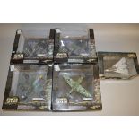 Four Unimax Forces of Valor 1:32 scale diecast aircraft, together with another in 1:72 scale.