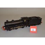 O Gauge. An electric kit-built 0-6-0 locomotive and tender in black.