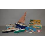 A selection of plastic, wooden and tinplate model boats, including three boxed items,