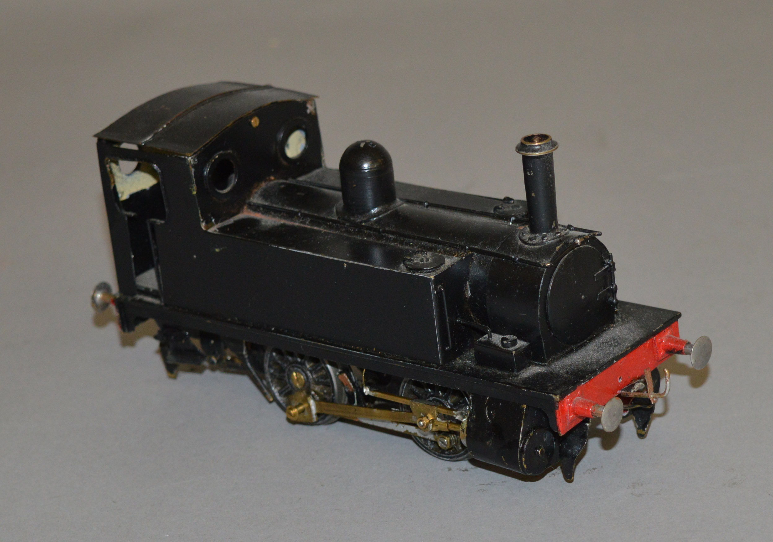 O Gauge. An electric kit-built 0-4-0 Pannier Tank locomotive in black.