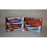 Four Mattel Hot Wheels 1:18 scale diecast models, including Ferrari and Cadillac. E in G boxes.