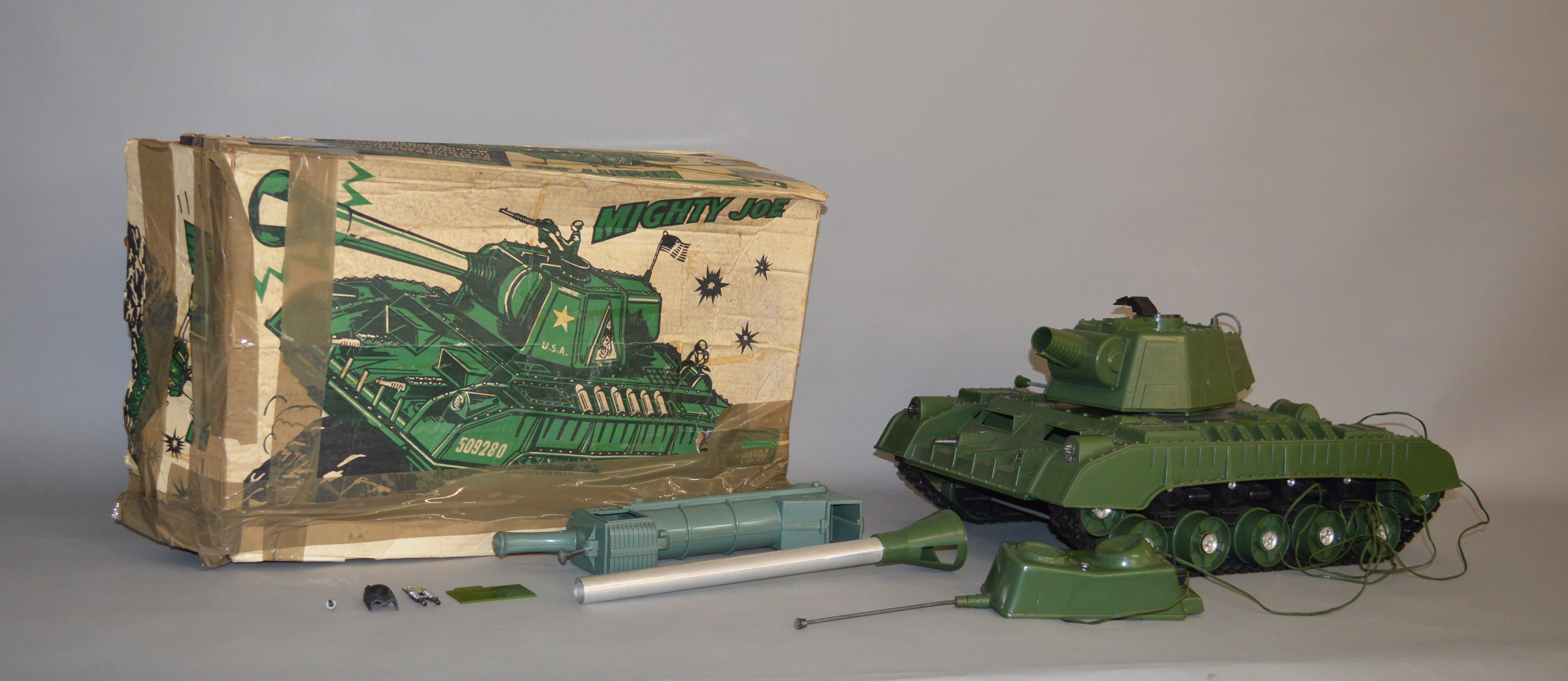 A boxed 'Mighty Joe' plastic battery operated remote control Tank, approximately 59cm long,