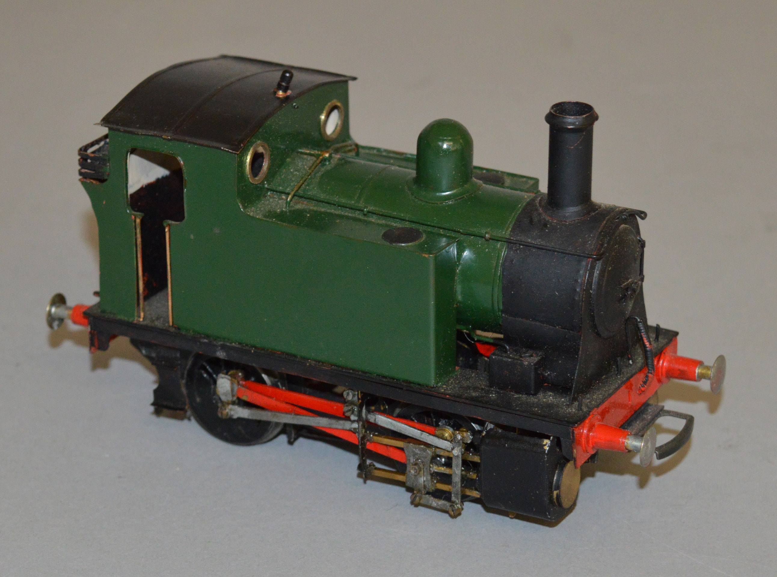 O Gauge. An electric kit-built 0-4-0 Pannier Tank locomotive in green/black.