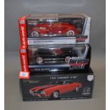 Two boxed ERTL Collectibles diecast model cars in 1:18 scale,