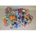 A quantity of unboxed Hasbro Transformers and other transforming robot toys by Bandai and others,