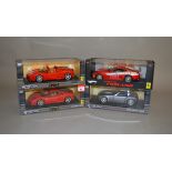 Four Hot Wheels 1:18 scale diecast model cars: Ferrari F430; Ferrari F430 Spider; Ford Shelby Cobra;