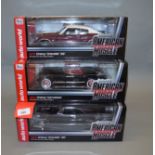 Three boxed ERTL Collectibles diecast model cars in 1:18 scale,