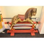 Wooden rocking horse, dapple painted, on wooden stand. Height approx. 110cm.