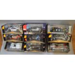 Nine Maisto 1:18 scale diecast model cars, including Mercedes-Benz and Porsche. E, boxed.