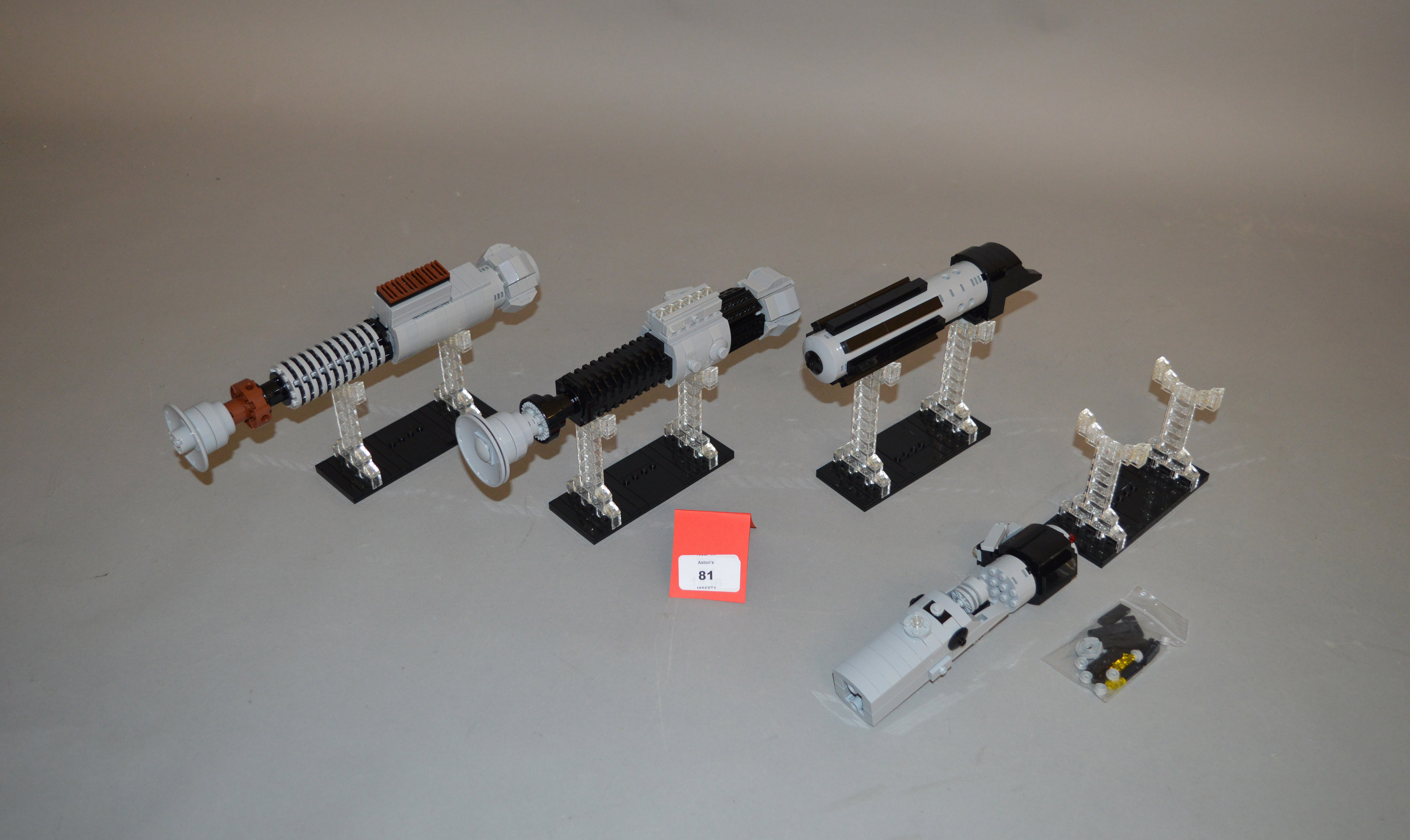 Four Star Wars lightsaber hilts, made from Lego.