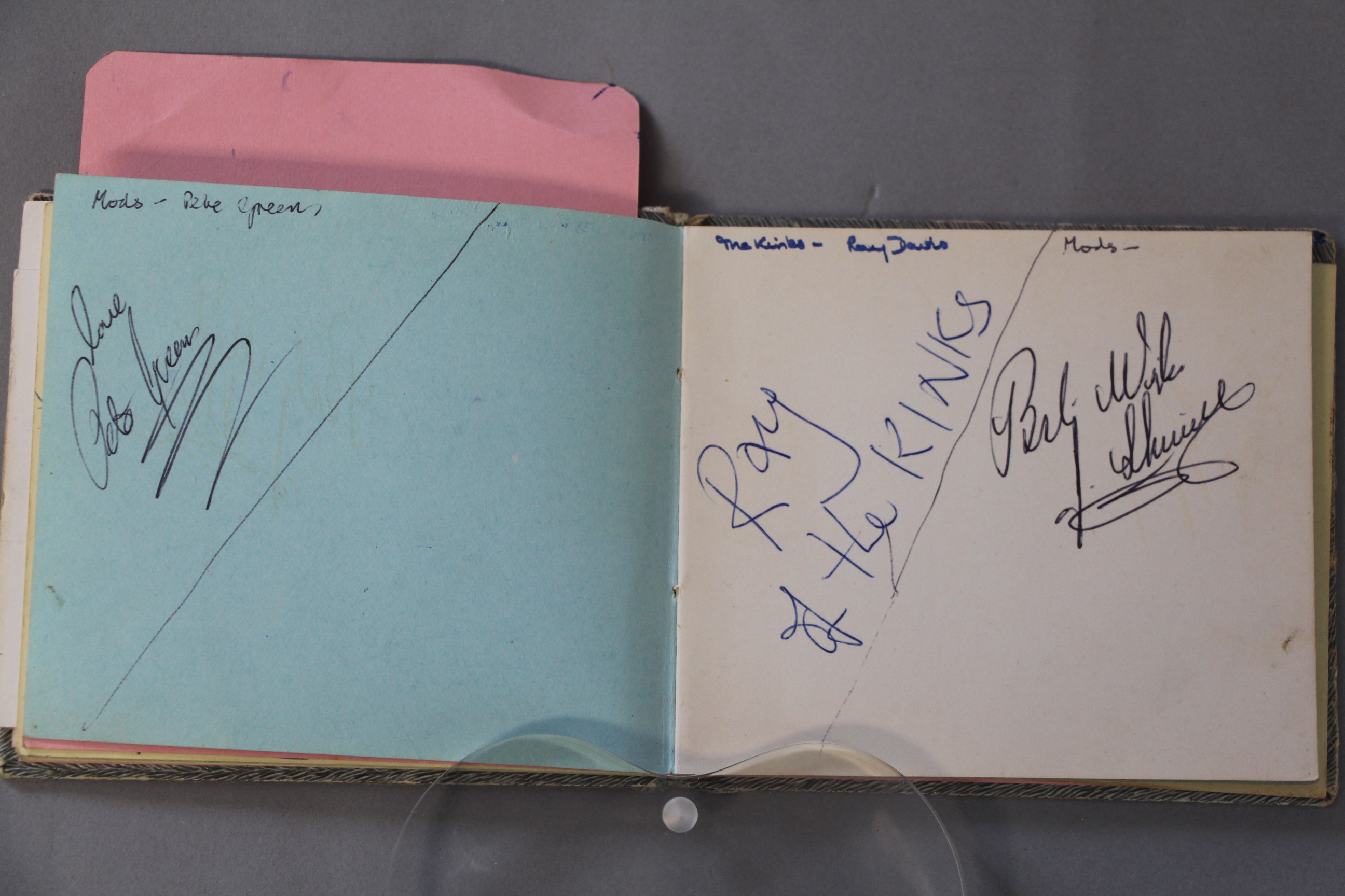 An autograph book with signatures and many car registrations of the groups collected personally by