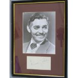 Clark Gable signature on paper, signed in black pen with black and white photo in frame.