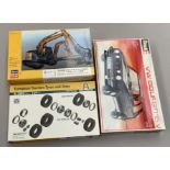 Three plastic model kits: Revell 7295 VW Golf 1:24 scale; Hasegawa 52161 Excavator;