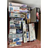 17 x plastic model kits, all cars, 1:24 and 1:25 scale, by Trumpeter, Italeri and similar.