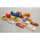 Twelve unboxed Corgi Toys diecast models with varying degrees of play wear,
