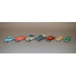 Seven unboxed Tri-ang Spot On diecast model cars with varying degrees of play wear including a