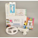 Nintendo Wii Family Edition console, together with eight games, steering wheel, gun, controller,