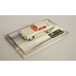 An unboxed Corgi Toys Rover 2000 model with chrome finish screwed to a two tier plastic plinth,