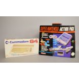 A boxed Commodore 64 together with a Super Nintendo Action Pack, also boxed,