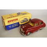 A boxed Victory Models Austin A40 Somerset plastic bodied battery operated model car in maroon,