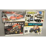 Three boxed battery operated Radio Control vehicles,