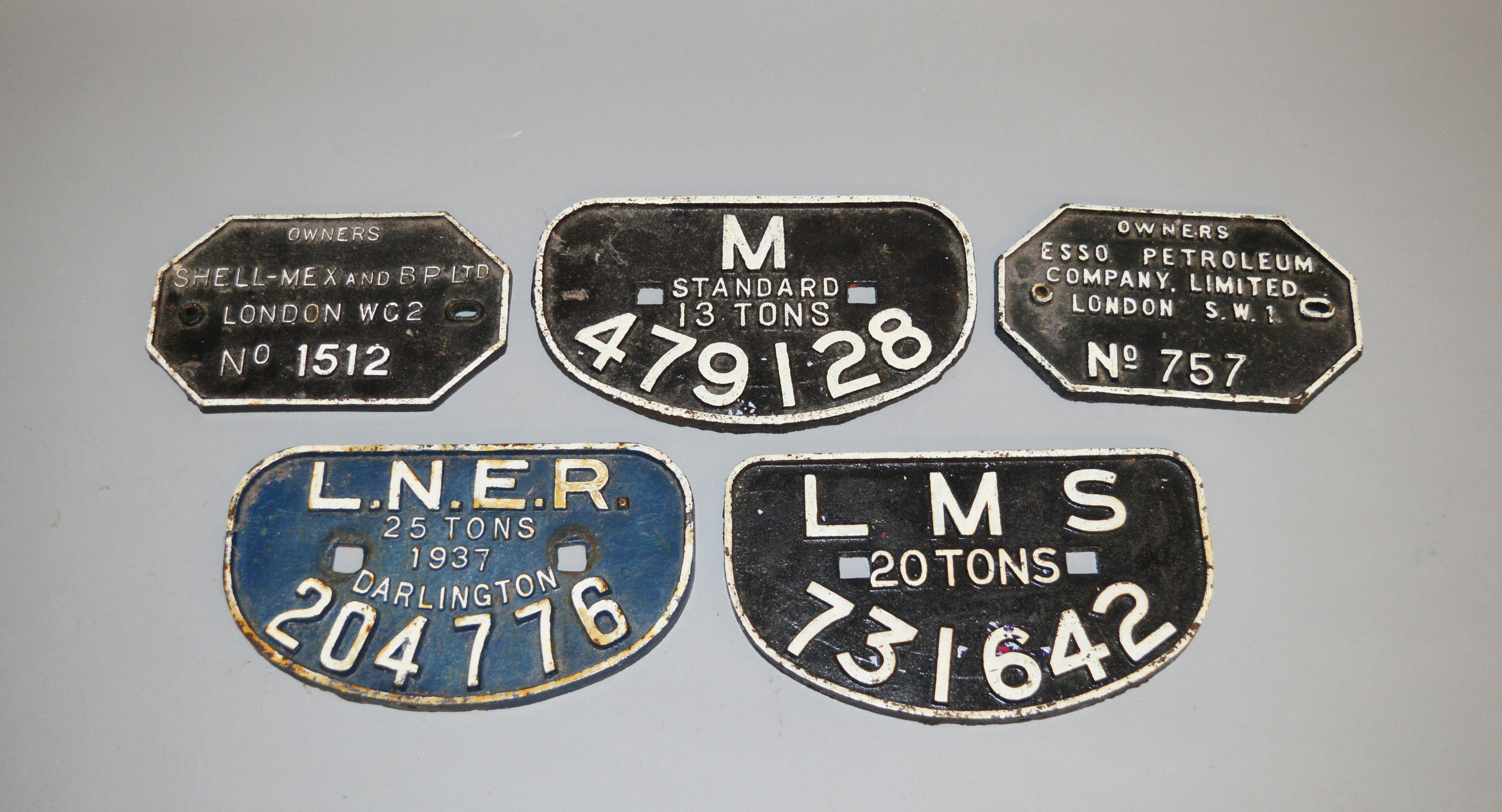 Five vintage cast iron Wagon Plates, including: Esso; Shellmex; LNER; LMS; Midland Region.