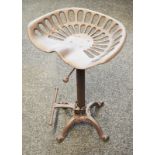 A Reproduction cast-metal tractor seat stool. Approx 68cm tall.