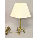A brass lamp with tripod base and shade. Height 32cm.