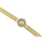 OMEGA - A 1960's 18ct ladies diamond set Omega wristwatch on integral 18ct bracelet hallmarked