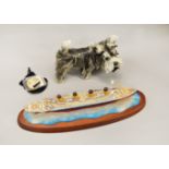 A dog ornament together with a model of RMS Titanic 100 years commemorative medallion.