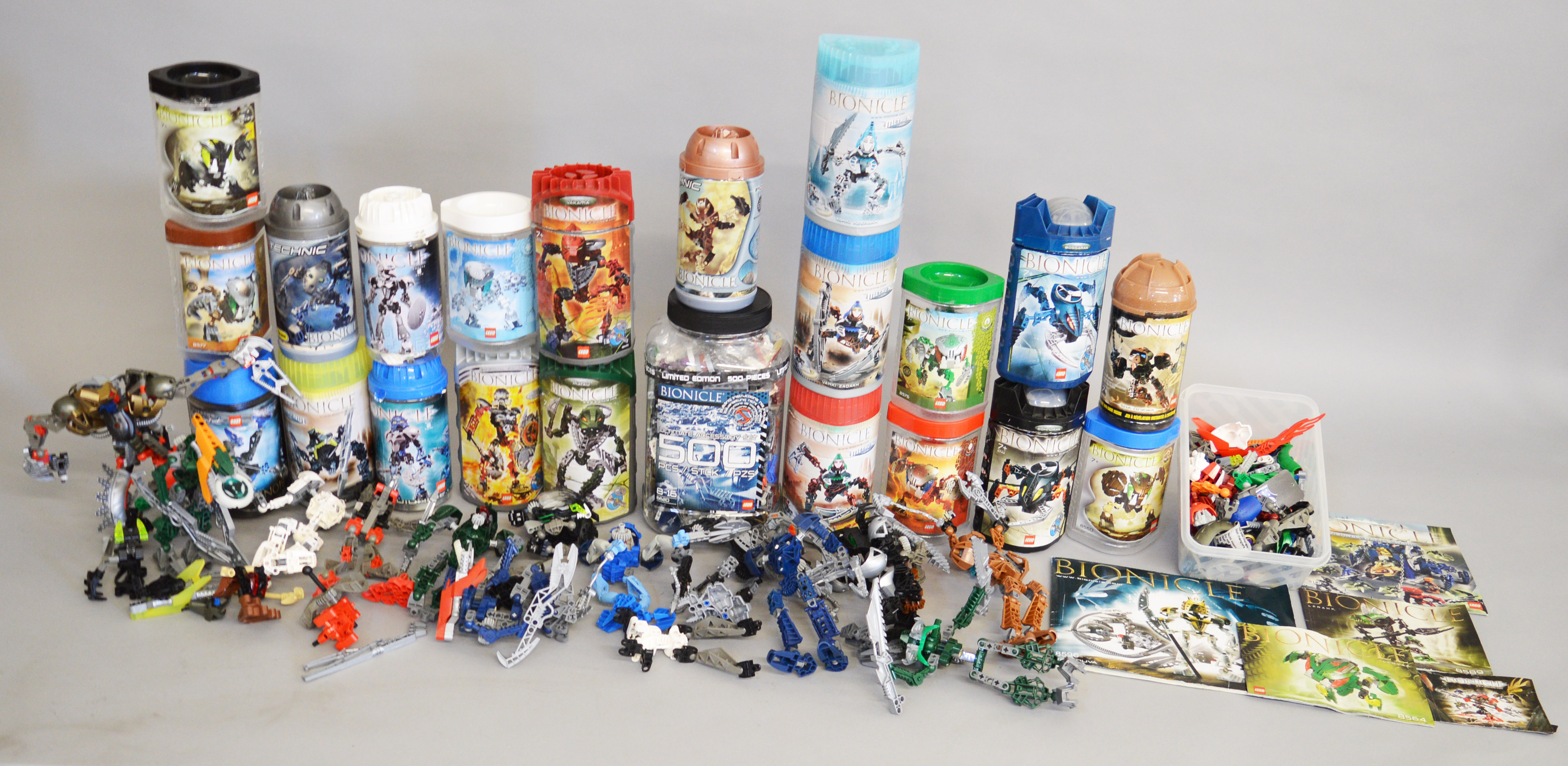 Twenty one opened packages for Lego Bionicle figures, some with contents,