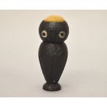 A (possibly Victorian) ebony Owl pin-cushion with glass eyes. Height 8.5cm.