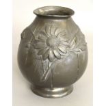 An Art Deco pewter vase. Embossed decoration of flowers.