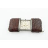 A Movado Ermento stainless steel travelling watch in a brown crocodile leather case, circa 1950's,