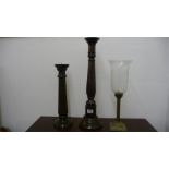 A pair of wooden candlesticks and one other