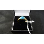 An 18ct gold ring set with a turquoise -total weight 5.12g