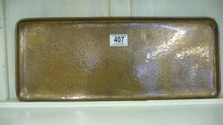 A rectangular hammered copper tray stamped "Newlyn"