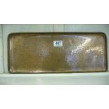 A rectangular hammered copper tray stamped "Newlyn"