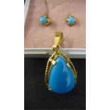 A Turquoise pendant set in Continental gold mount along with similar pair of earrings set in 18ct