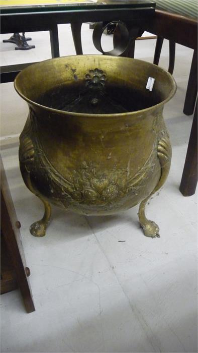 A brass cauldron shaped coal bin on three legs