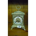 A brass mantle clock with German movement and Roman Numerals, two bells chimes- key in office